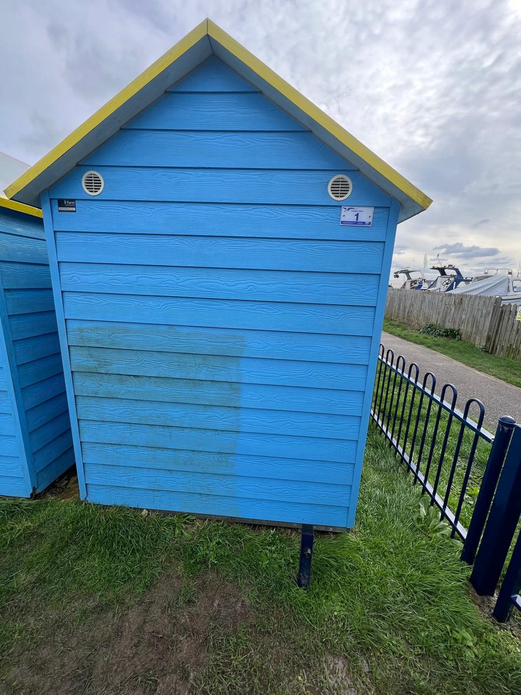 A blue beach hut cleaned on the coast in West Sussex