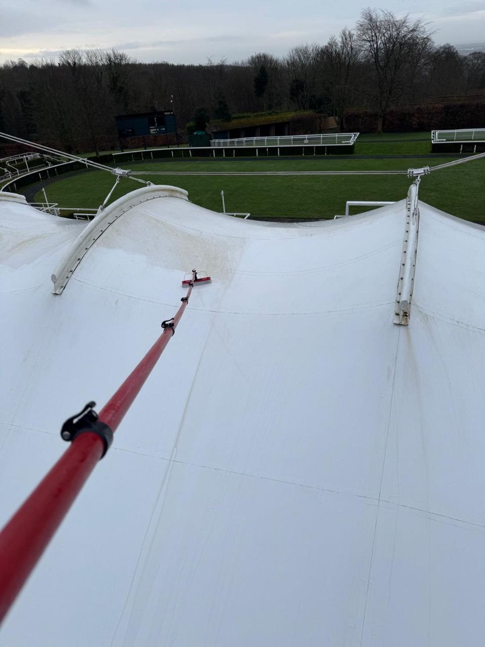 Cleaning a tensile fabric canopy roof at a racecourse grandstand in West Sussex