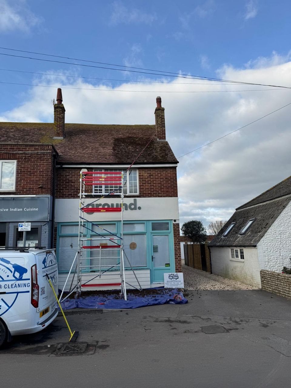 Shopfront render cleaning with tower access in West Sussex