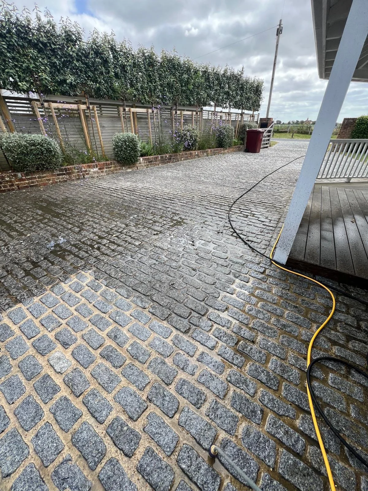 Driveway cleaning lifting dirt from paving in West Wittering