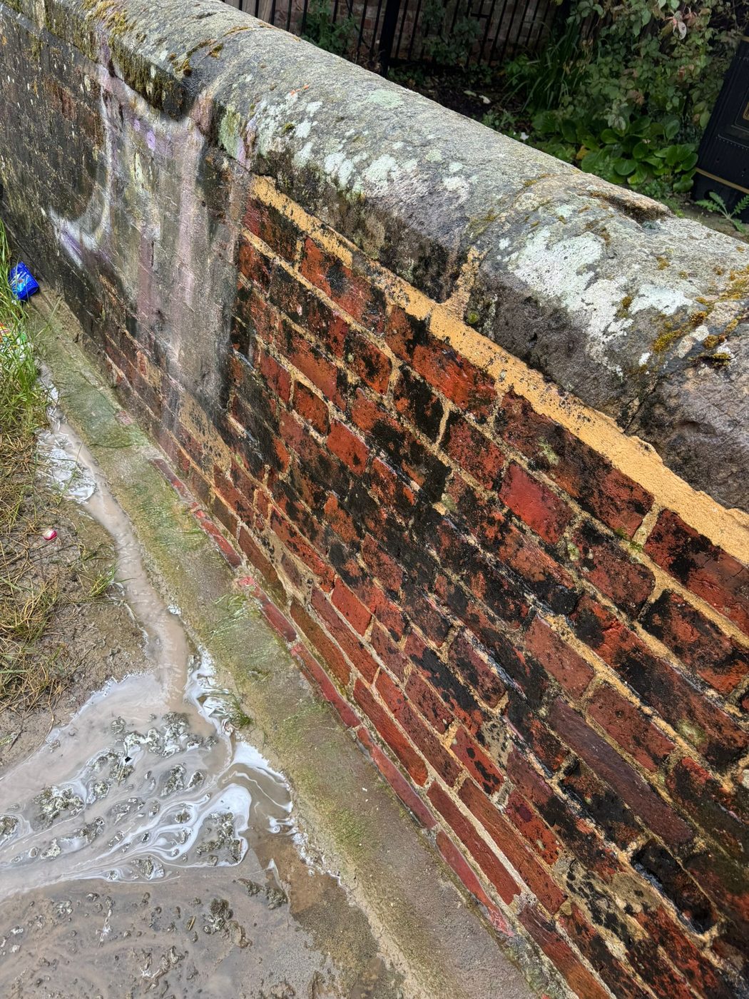 Soft washing an old brick and flint heritage wall