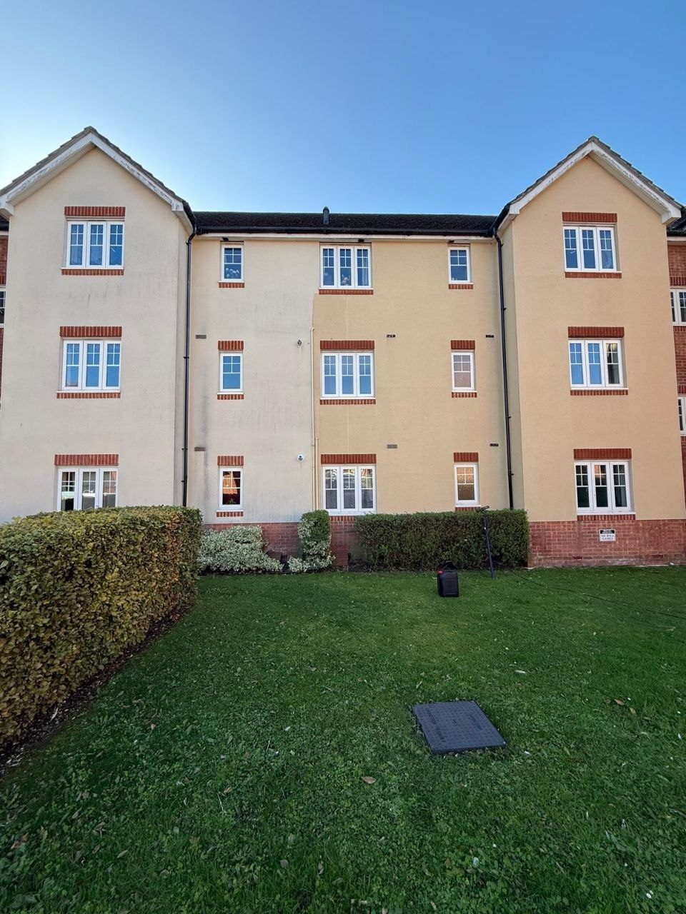 A rendered apartment block cleaned of algae staining