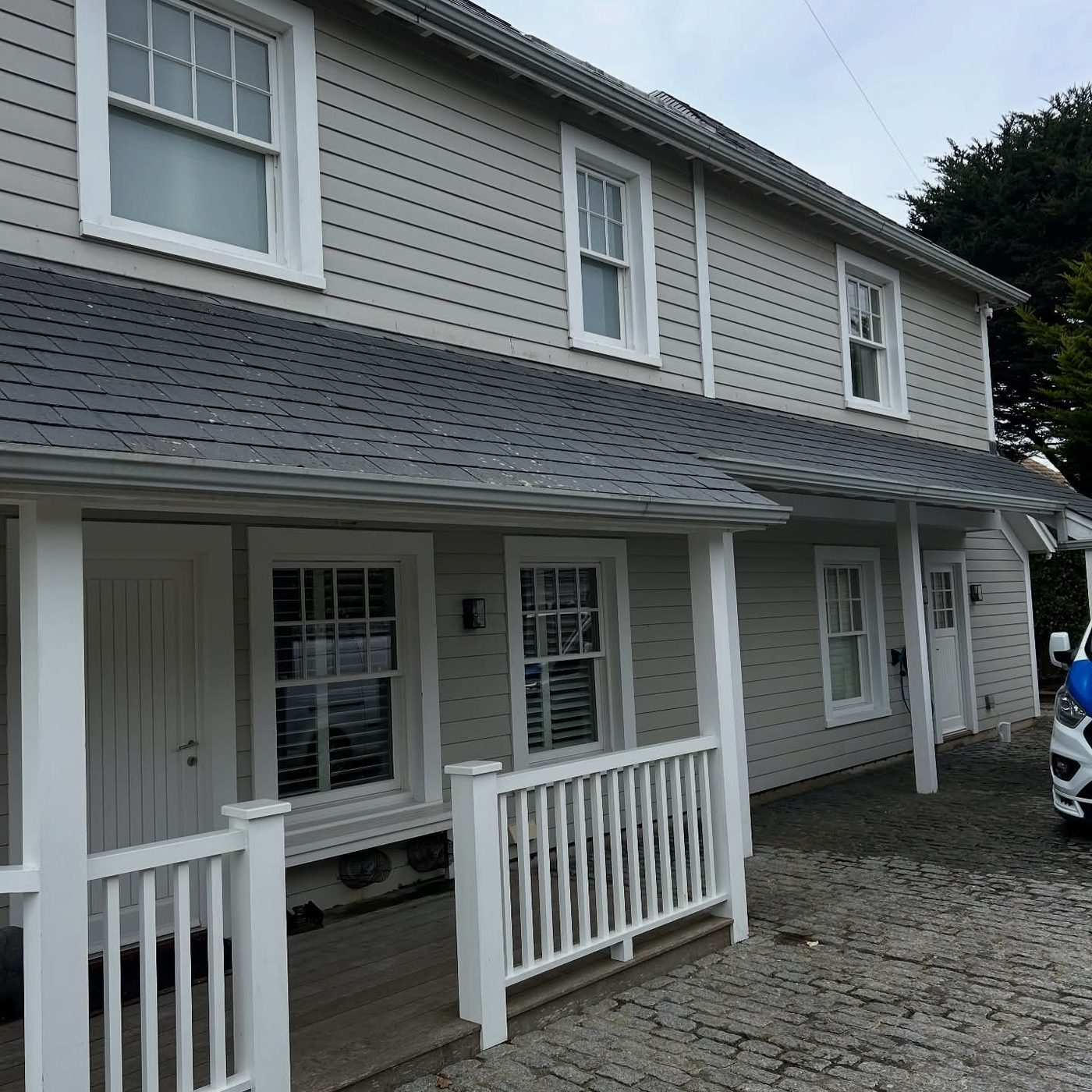 Cleaned render and weatherboard cladding on a coastal home