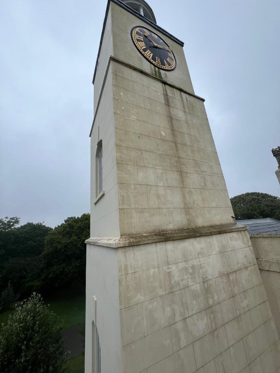 Cleaning the stonework around the clock face of the Hotham Park tower
