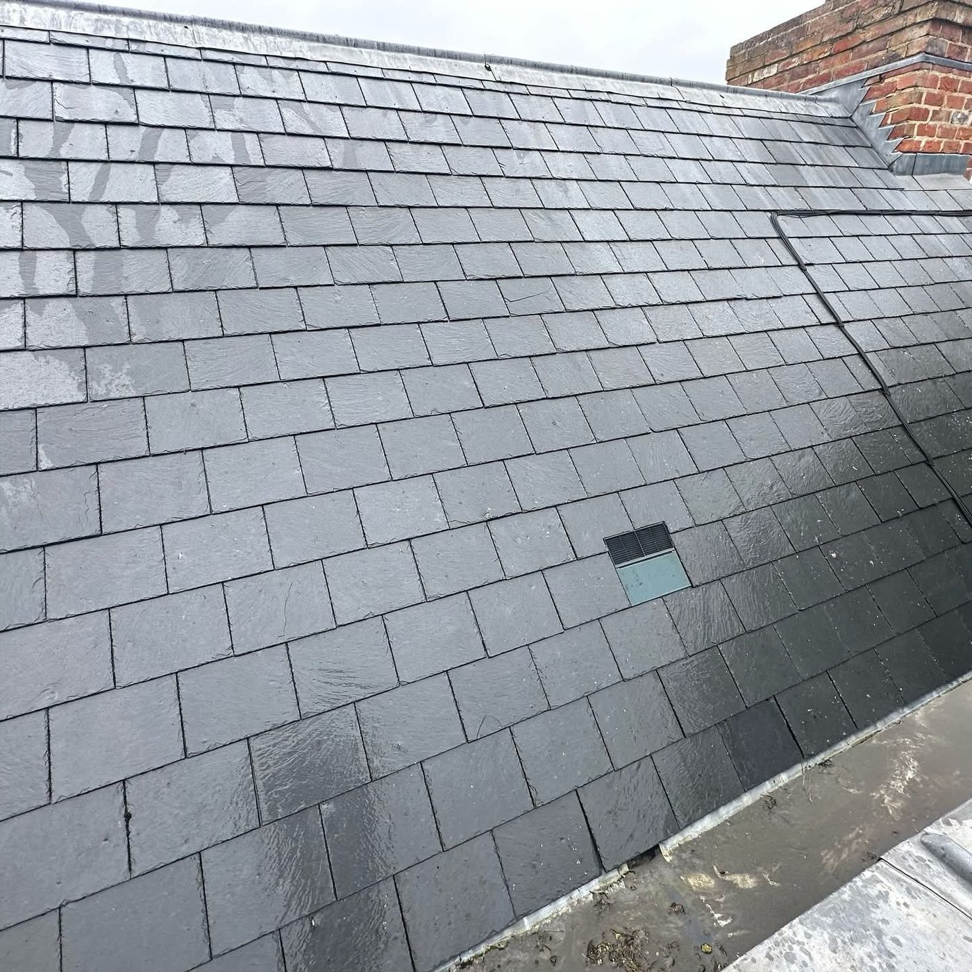 A slate roof cleaned of moss and algae